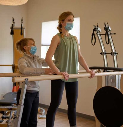 two women doing physio therapy at a clinic