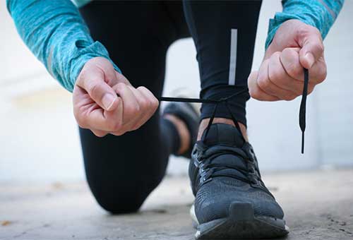 a photo of a person tying his shoe