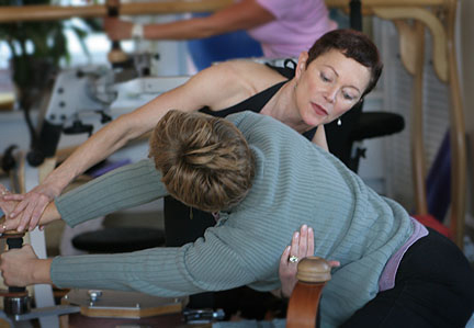 Kathy van Patten stretching with a client
