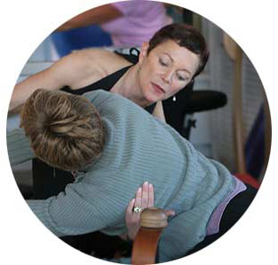 Kathy van Patten stretching with a client