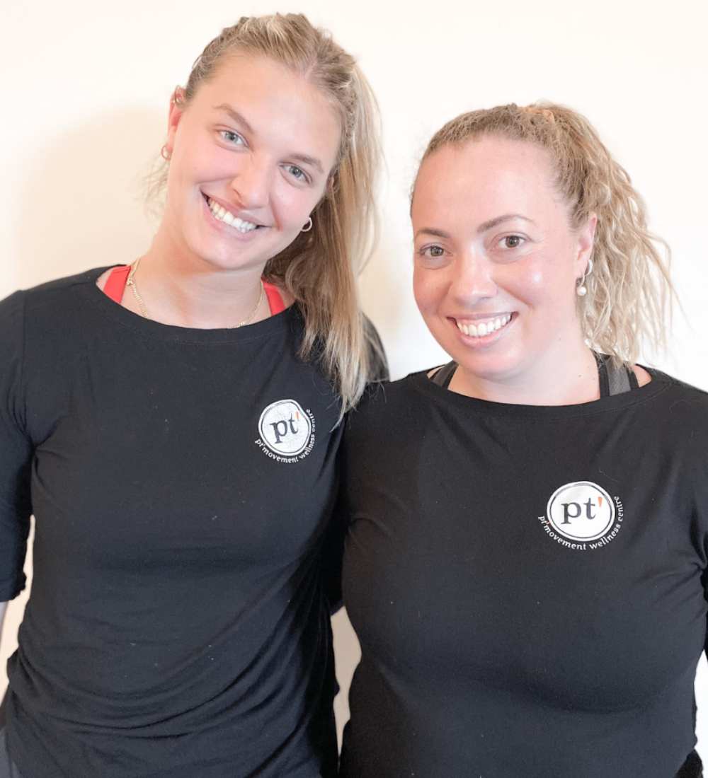 two sports women in black dress smiling