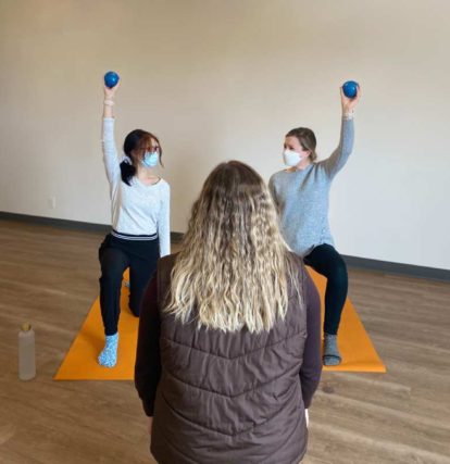 2 girls with yoga instructor