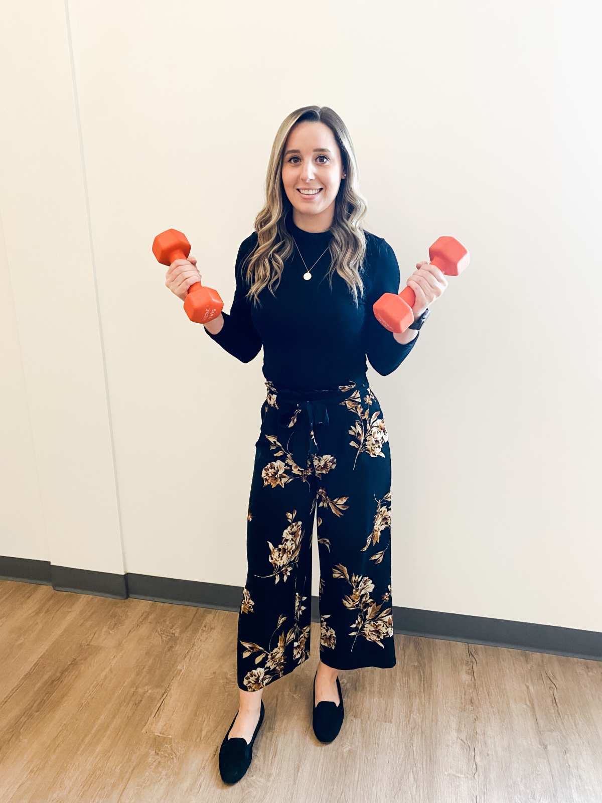 Dr. Vanessa holding a barbell in each hand