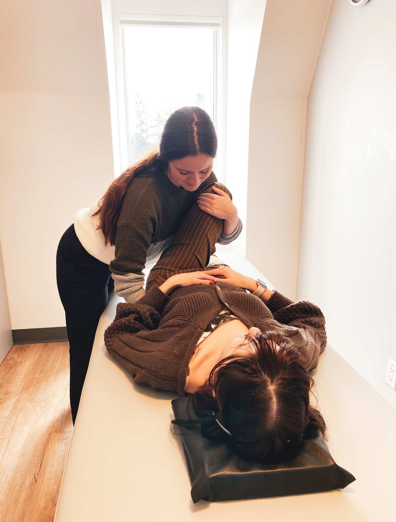 trainer helping a client on a stretching machine