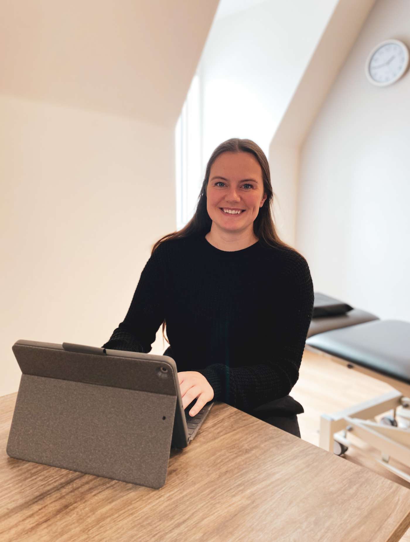 a woman sitting at a table with a laptop