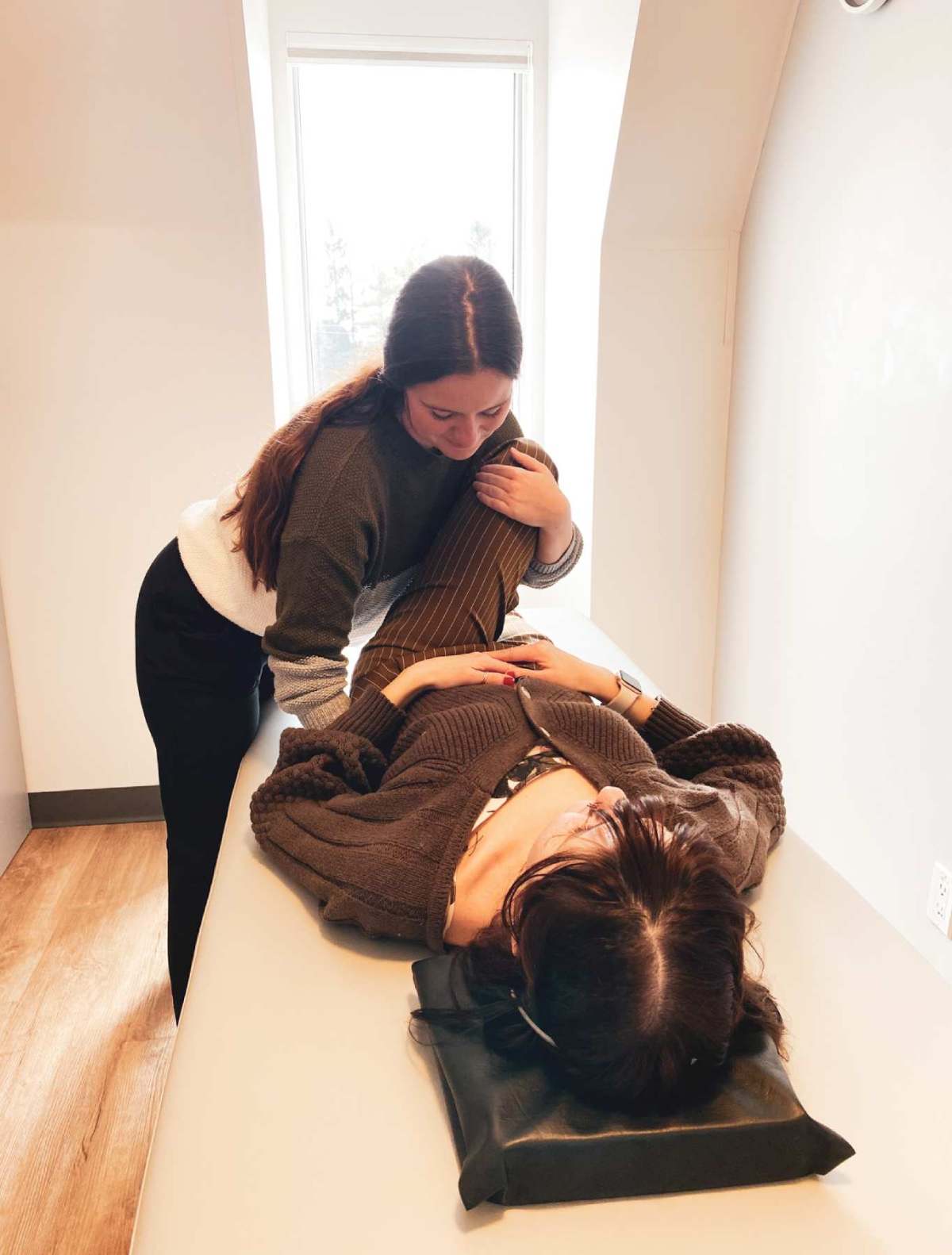 a therapist stretching a patient's leg