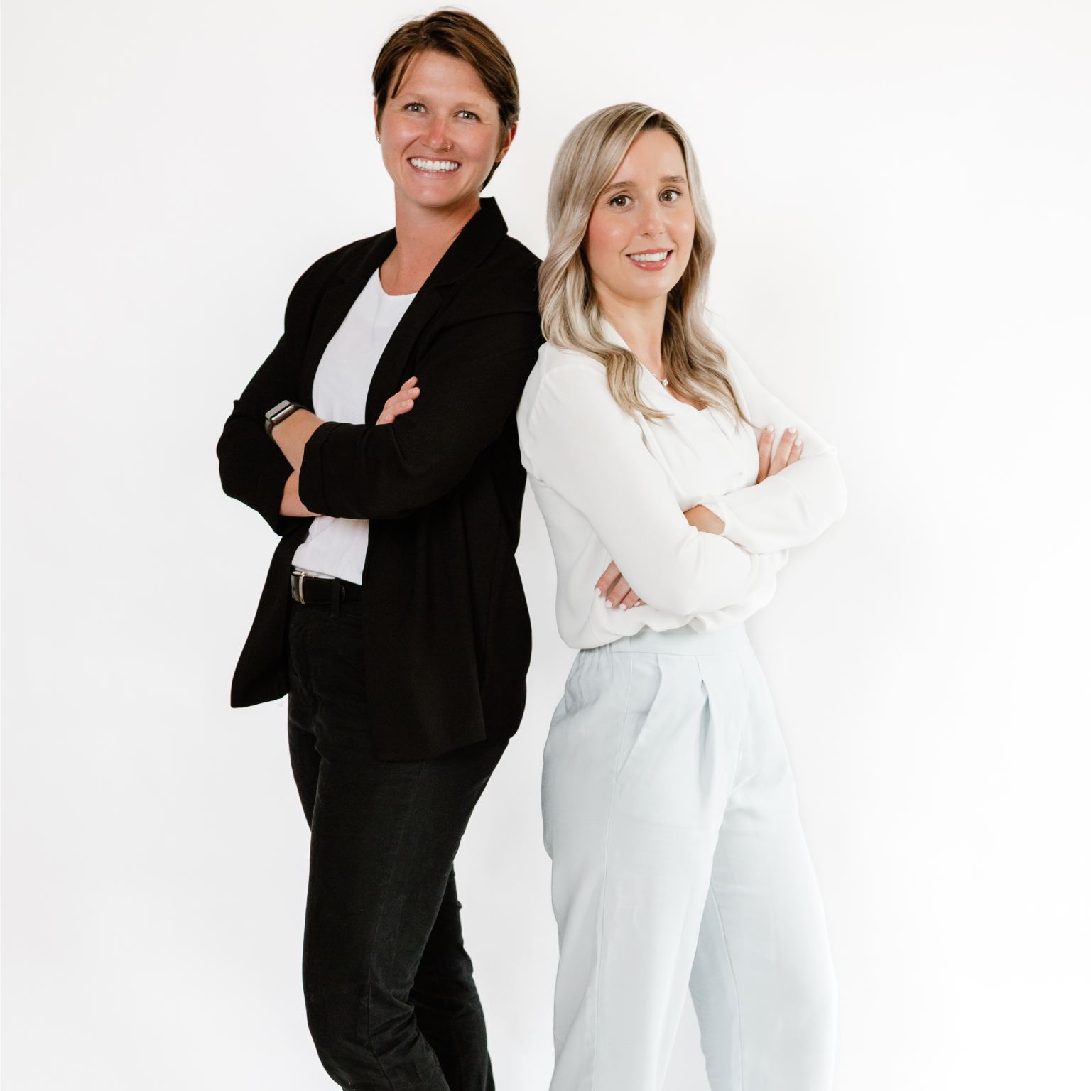 Two women standing side by side giving pose for photo