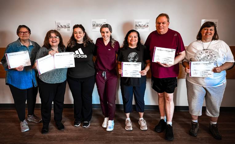 a group of people holding up certificates