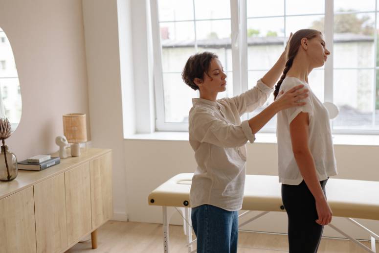 a woman rotating a patient's neck